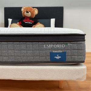 a mattress with a brand name Emporio Eternity with flushy bear on top